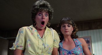 Movie still from “Raising Arizona” (1987), directed by Joel Coen – Two women standing next to each other and looking surprised; Close Up shot, Low angle