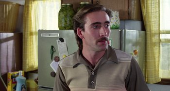 Movie still from “Raising Arizona” (1987), directed by Joel Coen – A person in a kitchen; Close Up shot, Low angle