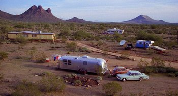 Movie still from “Raising Arizona” (1987), directed by Joel Coen – An rv parked in the middle of the desert; Extreme Wide shot, High angle