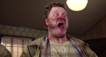 Movie still from “Raising Arizona” (1987), directed by Joel Coen – A person sticking out his tongue; Close Up shot, Low angle