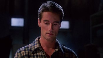 Movie still from “Re-Animator” (1985), directed by Stuart Gordon – A person wearing a plaid shirt; Close Up shot, Low angle