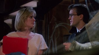 Movie still from “Re-Animator” (1985), directed by Stuart Gordon – A man and a woman talking to each other; Medium shot, Over the shoulder angle