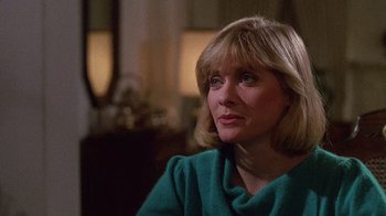 Movie still from “Re-Animator” (1985), directed by Stuart Gordon – A person sitting in a room; Close Up shot, Over the shoulder angle