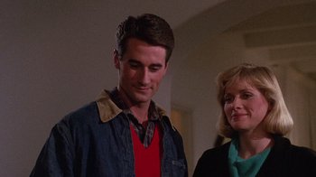 Movie still from “Re-Animator” (1985), directed by Stuart Gordon – A man standing next to a woman in a room; Close Up shot, Low angle