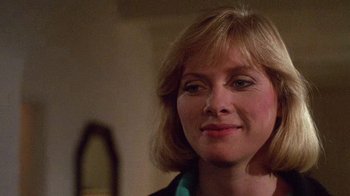 Movie still from “Re-Animator” (1985), directed by Stuart Gordon – A person wearing a jacket; Close Up shot, Over the shoulder angle