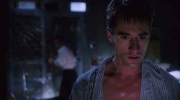 Movie still from “Re-Animator” (1985), directed by Stuart Gordon – A person wearing a striped shirt; Close Up shot, Low angle