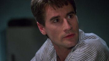 Movie still from “Re-Animator” (1985), directed by Stuart Gordon – A person wearing a striped shirt; Close Up shot, Low angle