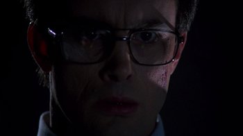 Movie still from “Re-Animator” (1985), directed by Stuart Gordon – A person wearing glasses with blood on his face; Close Up shot, Low angle