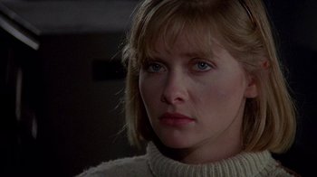 Movie still from “Re-Animator” (1985), directed by Stuart Gordon – A person wearing a sweater; Close Up shot, Over the shoulder angle