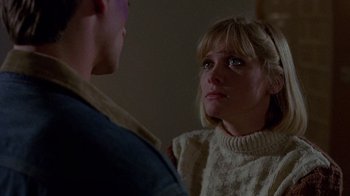 Movie still from “Re-Animator” (1985), directed by Stuart Gordon – A man and a woman looking at one another; Close Up shot, Over the shoulder angle