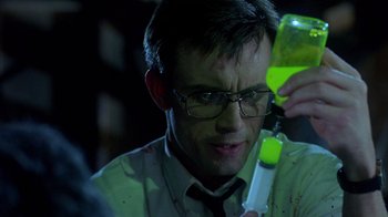 Movie still from “Re-Animator” (1985), directed by Stuart Gordon – A man holding a cell phone in his hand; Close Up shot, Over the shoulder angle
