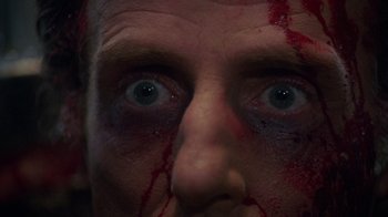 Movie still from “Re-Animator” (1985), directed by Stuart Gordon – A person's eyes with blood on them; Extreme Close Up shot, Overhead angle