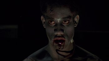 Movie still from “Re-Animator” (1985), directed by Stuart Gordon – A person with blood on their face; Close Up shot, Low angle