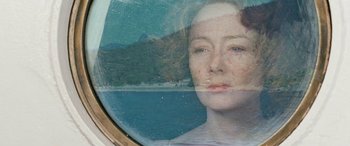 Movie still from “Reaching for the Moon” (2013), directed by Bruno Barreto – A woman's face in front of the ocean; Close Up shot, Overhead angle