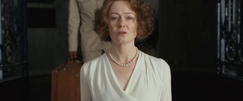 Movie still from “Reaching for the Moon” (2013), directed by Bruno Barreto – An older woman wearing a white dress and a pearl necklace; Close Up shot, Low angle