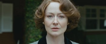 Movie still from “Reaching for the Moon” (2013), directed by Bruno Barreto – A person with short hair; Close Up shot, Over the shoulder angle