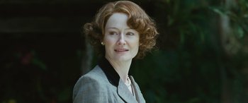 Movie still from “Reaching for the Moon” (2013), directed by Bruno Barreto – An older woman wearing a suit and a necklace; Close Up shot, Low angle