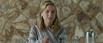 Movie still from “Reaching for the Moon” (2013), directed by Bruno Barreto – A woman in a striped shirt is talking to someone; Close Up shot, Over the shoulder angle