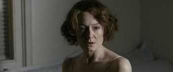 Movie still from “Reaching for the Moon” (2013), directed by Bruno Barreto – A person with short brown hair; Close Up shot, Over the shoulder angle