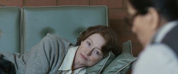 Movie still from “Reaching for the Moon” (2013), directed by Bruno Barreto – A person laying on a couch; Close Up shot, High angle