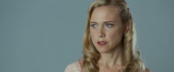 Movie still from “Reaching for the Moon” (2013), directed by Bruno Barreto – A person wearing a pink shirt; Close Up shot, Over the shoulder angle