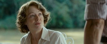 Movie still from “Reaching for the Moon” (2013), directed by Bruno Barreto – An older woman sitting on top of a white bench; Close Up shot, Over the shoulder angle