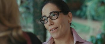 Movie still from “Reaching for the Moon” (2013), directed by Bruno Barreto – A person wearing glasses; Close Up shot, Over the shoulder angle