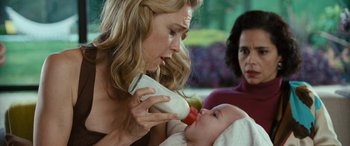 Movie still from “Reaching for the Moon” (2013), directed by Bruno Barreto – A woman feeding a bottle to a baby; Close Up shot, Over the shoulder angle