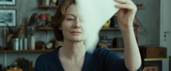 Movie still from “Reaching for the Moon” (2013), directed by Bruno Barreto – A person holding something in their hand; Close Up shot, Over the shoulder angle