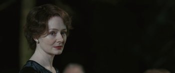 Movie still from “Reaching for the Moon” (2013), directed by Bruno Barreto – A person with short red hair; Close Up shot, Over the shoulder angle