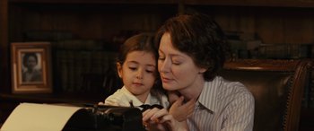 Movie still from “Reaching for the Moon” (2013), directed by Bruno Barreto – A woman and a child looking at something on a camera; Close Up shot, Over the shoulder angle