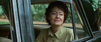 Movie still from “Reaching for the Moon” (2013), directed by Bruno Barreto – A woman sitting in the back seat of a car; Close Up shot, Over the shoulder angle