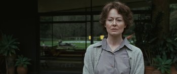 Movie still from “Reaching for the Moon” (2013), directed by Bruno Barreto – A woman standing in front of a window; Close Up shot, Low angle