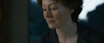 Movie still from “Reaching for the Moon” (2013), directed by Bruno Barreto – A woman's face in a black shirt; Close Up shot, Over the shoulder angle