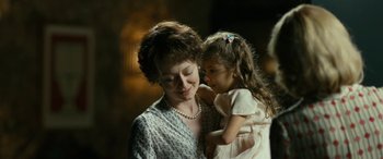 Movie still from “Reaching for the Moon” (2013), directed by Bruno Barreto – An older woman holding a little girl in her arms; Close Up shot, Over the shoulder angle