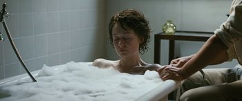 Movie still from “Reaching for the Moon” (2013), directed by Bruno Barreto – A woman sitting in a bath tub in a bathroom; Close Up shot, High angle