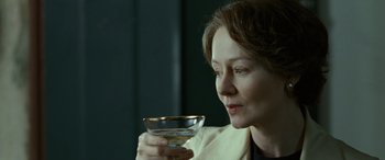 Movie still from “Reaching for the Moon” (2013), directed by Bruno Barreto – A woman is holding a wine glass in her hand; Close Up shot, Over the shoulder angle