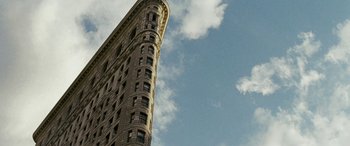 Movie still from “Reaching for the Moon” (2013), directed by Bruno Barreto – A very tall building in the middle of the day; Extreme Wide shot, Low angle