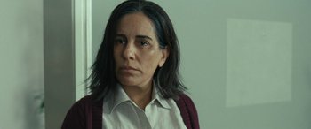 Movie still from “Reaching for the Moon” (2013), directed by Bruno Barreto – A person wearing a white shirt; Close Up shot, Over the shoulder angle