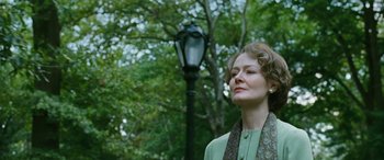 Movie still from “Reaching for the Moon” (2013), directed by Bruno Barreto – An older woman standing in front of a street light; Close Up shot, Low angle