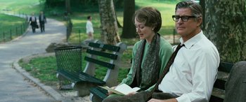 Movie still from “Reaching for the Moon” (2013), directed by Bruno Barreto – A woman sitting on a park bench reading a book; Medium shot, Over the shoulder angle