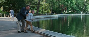 Movie still from “Reaching for the Moon” (2013), directed by Bruno Barreto – A man and a boy are walking by a pond; Wide shot, Over the shoulder angle