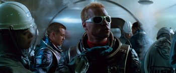 Movie still from “Red Planet” (2000), directed by Antony Hoffman – A man in a space suit and a man in a space suit; Close Up shot, Low angle