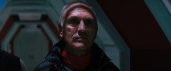 Movie still from “Red Planet” (2000), directed by Antony Hoffman – A person wearing a black jacket; Close Up shot, Low angle
