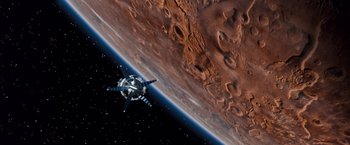 Movie still from “Red Planet” (2000), directed by Antony Hoffman – An image of a space station in the middle of the earth; Extreme Wide shot, Overhead angle