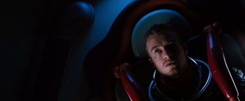 Movie still from “Red Planet” (2000), directed by Antony Hoffman – A man looking into a mirror in the dark; Close Up shot, Overhead angle