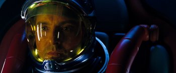 Movie still from “Red Planet” (2000), directed by Antony Hoffman – A man wearing a space helmet sitting in a car; Close Up shot, Overhead angle
