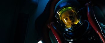Movie still from “Red Planet” (2000), directed by Antony Hoffman – A person wearing a space suit in a space ship; Close Up shot, Overhead angle