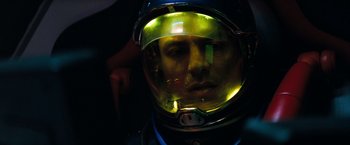 Movie still from “Red Planet” (2000), directed by Antony Hoffman – A man wearing a space helmet in the dark; Close Up shot, Low angle