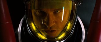 Movie still from “Red Planet” (2000), directed by Antony Hoffman – A person wearing a helmet; Close Up shot, Low angle